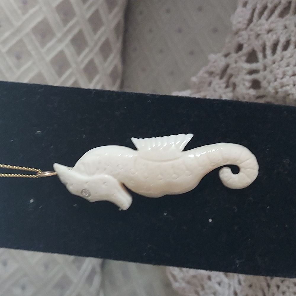 Ivory colored seahorse pendant and chain with .20 genuine diamond in eye....